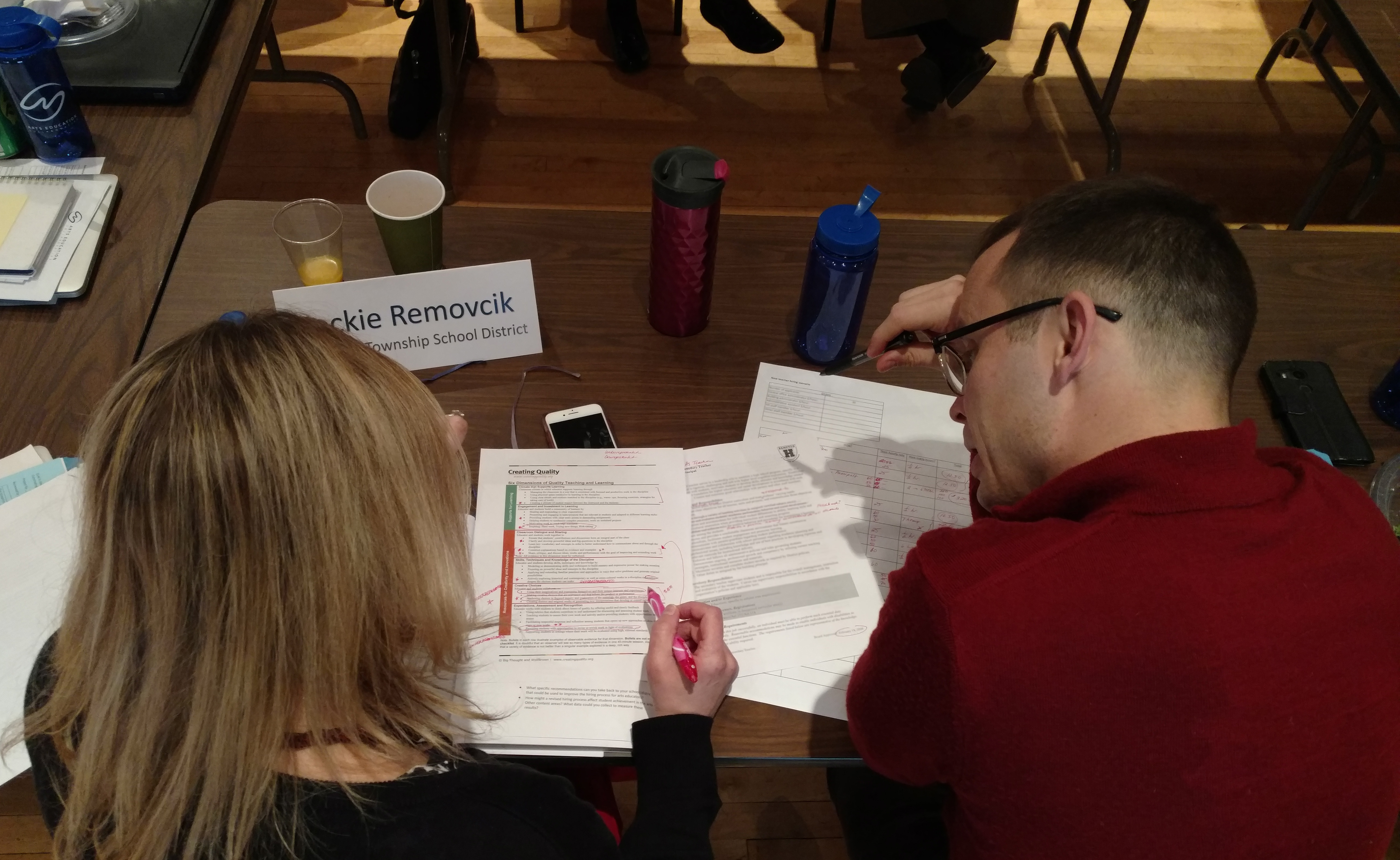 Dr. Jacquelyn Removcik and another administrator look closely at interview protocols.