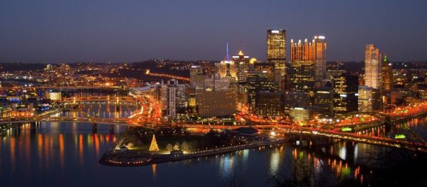 The image depicts the Pittsburgh skyline at night