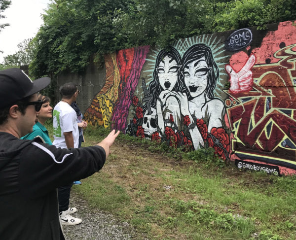 A teaching artist discusses graffiti with a group of teachers.