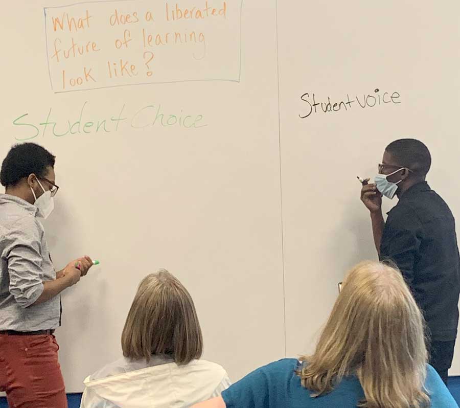 two people work on whiteboard