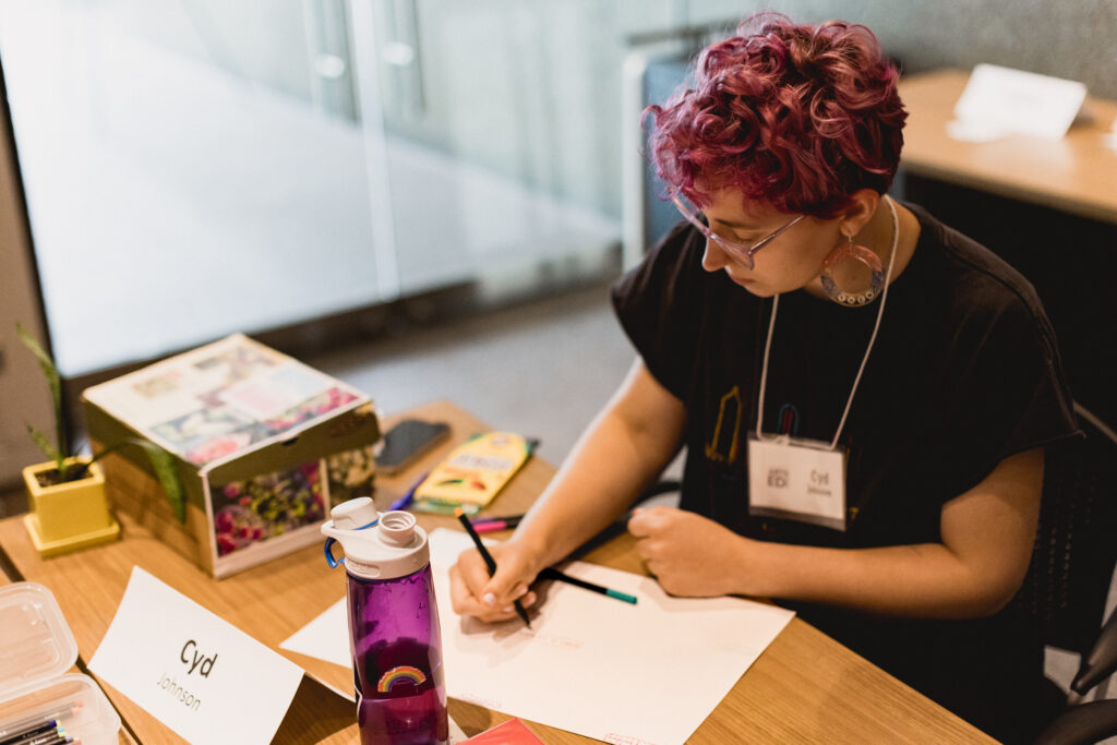 Person writes on a piece of paper.